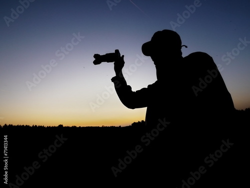 man photographing silhouette