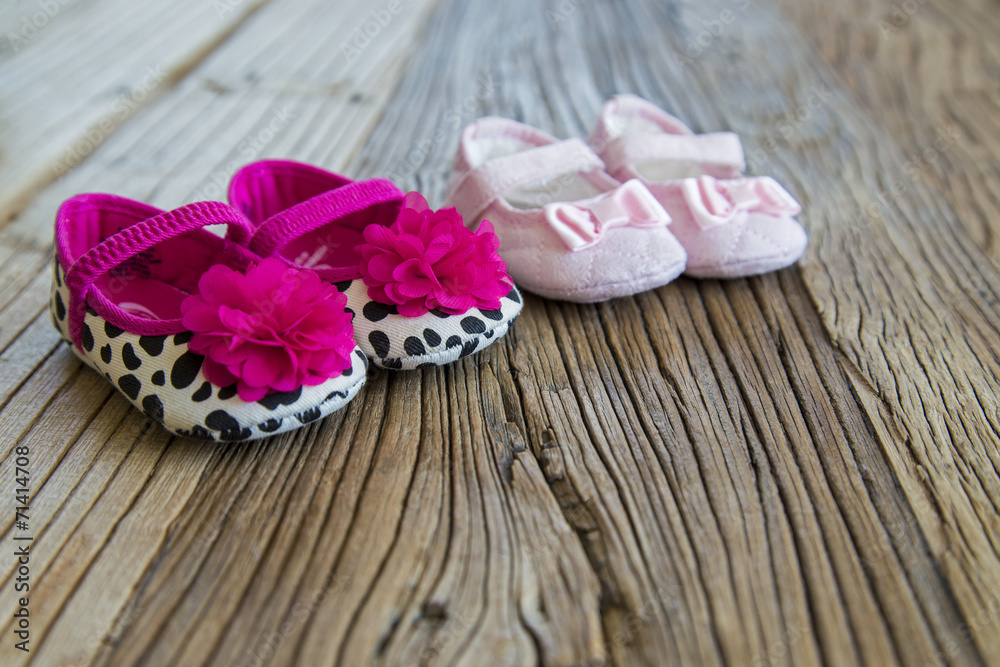 Sweet fancy and colorful baby shoes on the wooden table Sweet fancy and colorful baby shoes on the wooden table
