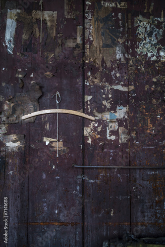 Distressed wooden panel with burnt torn newspaper clippings