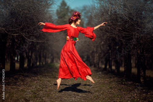 Canvas Print Girl in red dress soars.