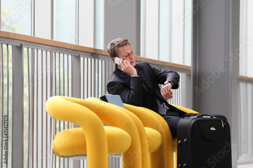 businessman sitting talking on the phone, on a business trip