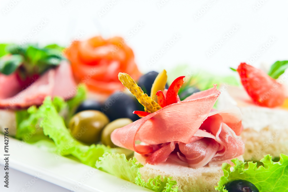 Cold snack with  ham,  salmon and olives