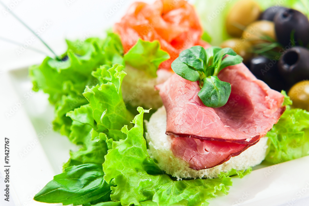 Cold snack with ham, salmon and olives Cold snack with ham, salmon and olives