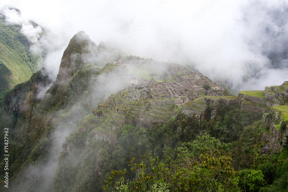 The Incan ruins of Machu Picchu in mist, Peru