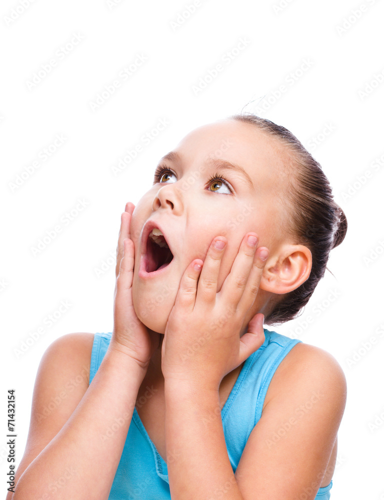 Cute girl is holding her face in astonishment Cute girl is holding her face in astonishment