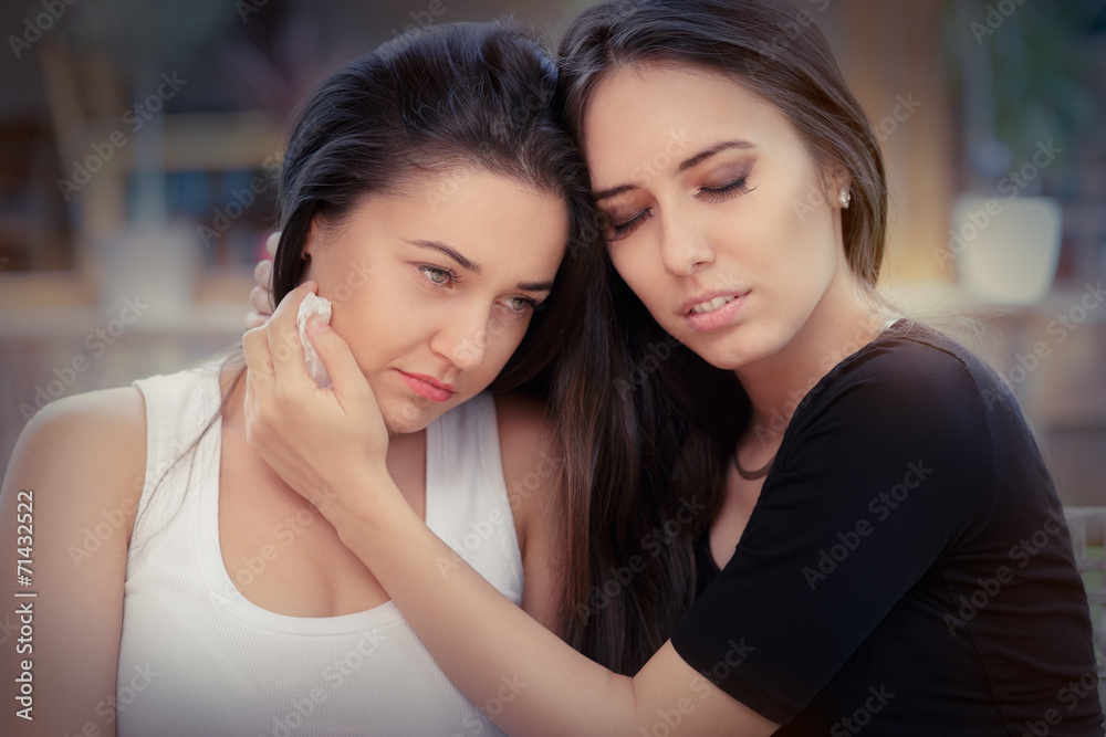 Young woman comforting tearful friend Young woman comforting tearful friend