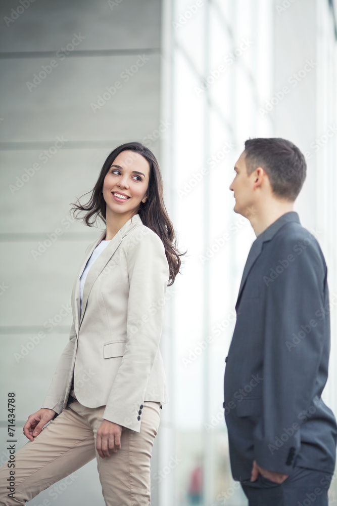 Smiling coworkers in front of the office building Smiling coworkers in front of the office building