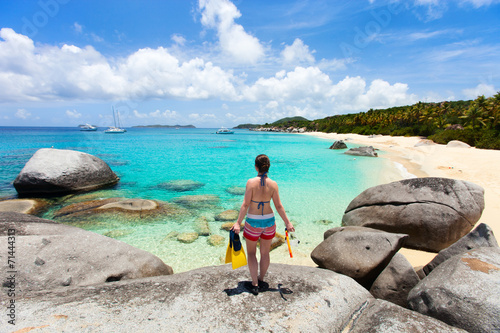 Woman with snorkeling equipment at tropical beach