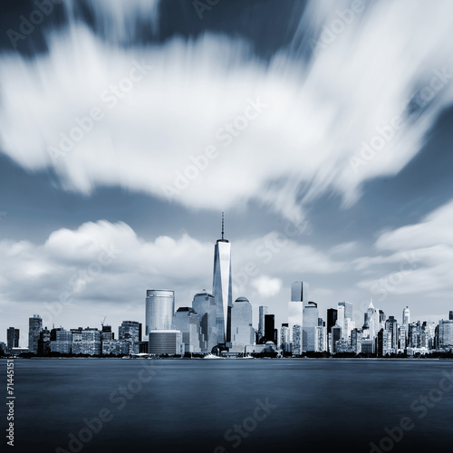 Modern Manhattan cityscape in blue color with blurred sky