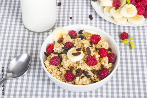granola with fruits and bottle of fresh milk