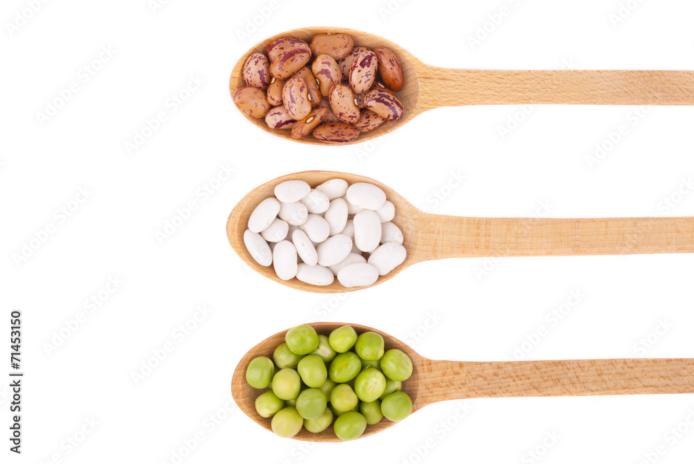 Beans and green peas in a spoon on a white background. Beans and green peas in a spoon on a white background.