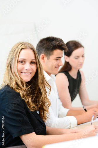 cheerful young business woman with partners in  meeting room