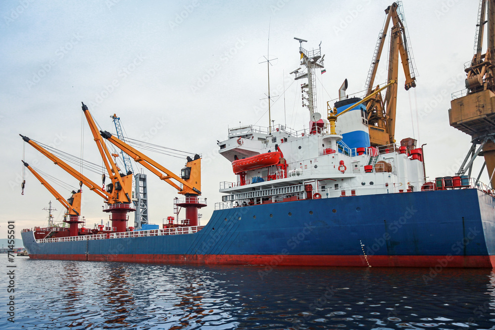 Blue industrial cargo ship is loading in port of Varna