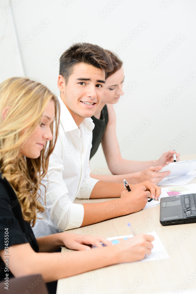 handsome young businessman in meeting room with partners handsome young businessman in meeting room with partners