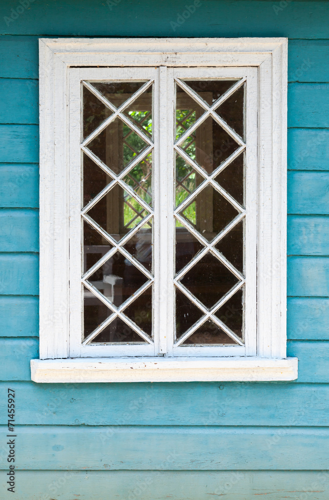 Old Russian rural house fragment, blue wall and white window Old Russian rural house fragment, blue wall and white window