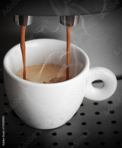 Espresso preparing, white ceramic cup in coffee machine