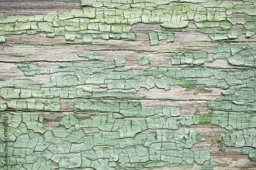 Old green weathered wooden wall with cracked paint