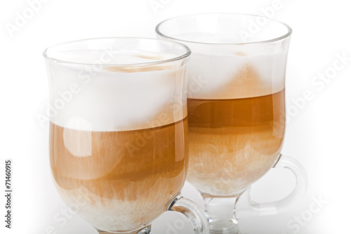 Two big mugs with handles of latte coffee, macro photo