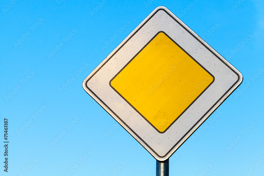 Main road yellow roadsign above clear blue sky background Main road yellow roadsign above clear blue sky background