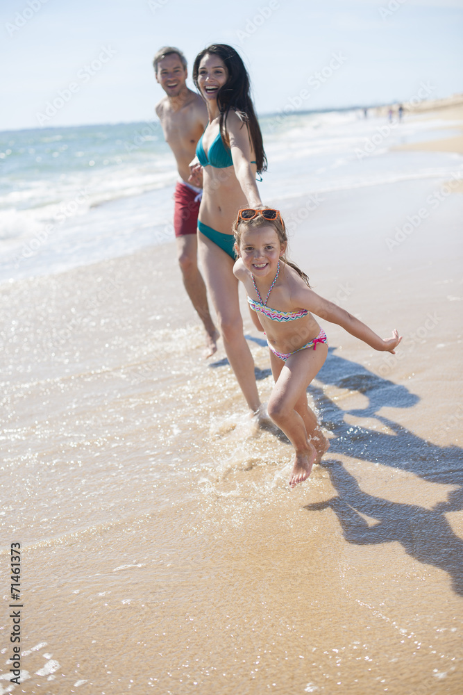 happy family in swimsuit having fun in the beach happy family in swimsuit having fun in the beach