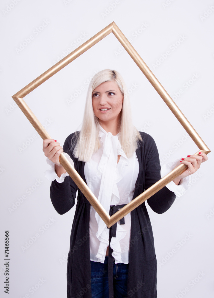 Portrait of a young blond woman holding a frame Portrait of a young blond woman holding a frame