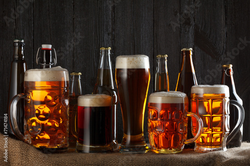 Assortment of beer glasses on table with burlap cloth