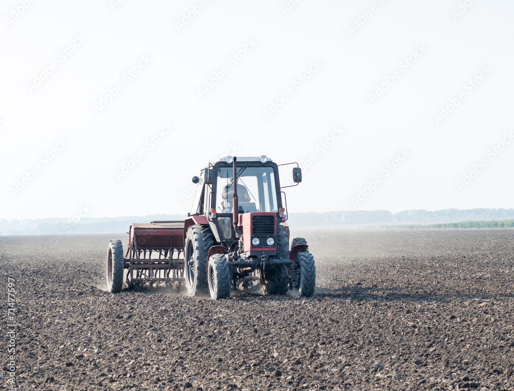 tractor and seeder planting crops on a field tractor and seeder planting crops on a field