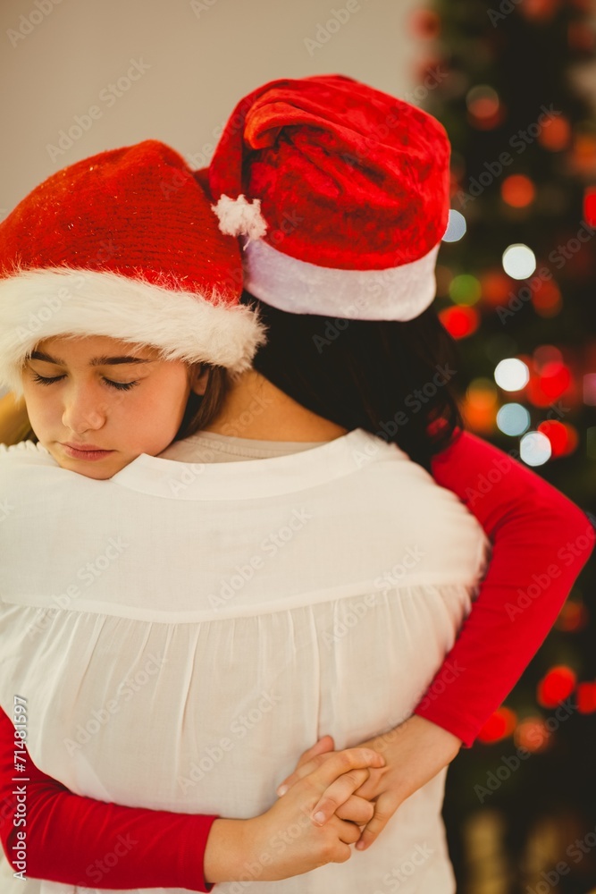Fototapeta premium Mother and daughter hugging at christmas