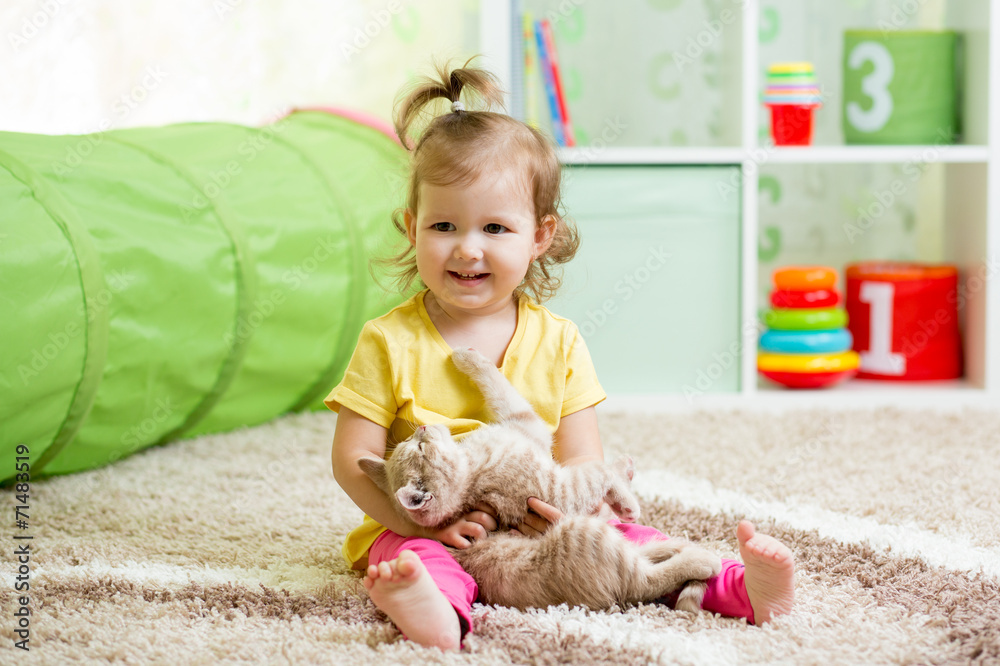 little girl playing and hugging loving pet kitten little girl playing and hugging loving pet kitten