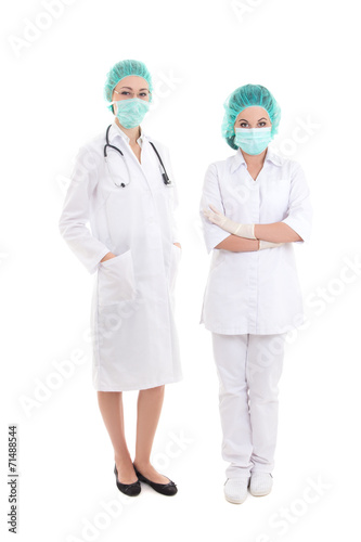 two full length young women doctor in surgical mask and cap isol