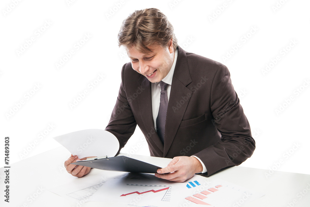 Man wearing suit sitting in desk observing charts Man wearing suit sitting in desk observing charts