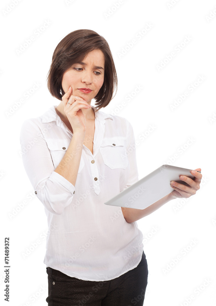 Woman holding an electronic tablet and looking doubtful Woman holding an electronic tablet and looking doubtful