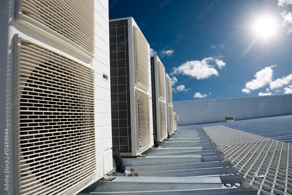 Air conditioner units with sun and blue sky - obrazy, fototapety, plakaty 