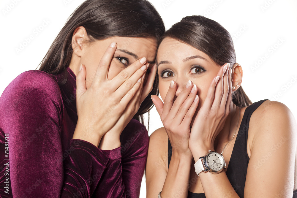 Ashamed young women covering their faces with their hands Ashamed young women covering their faces with their hands