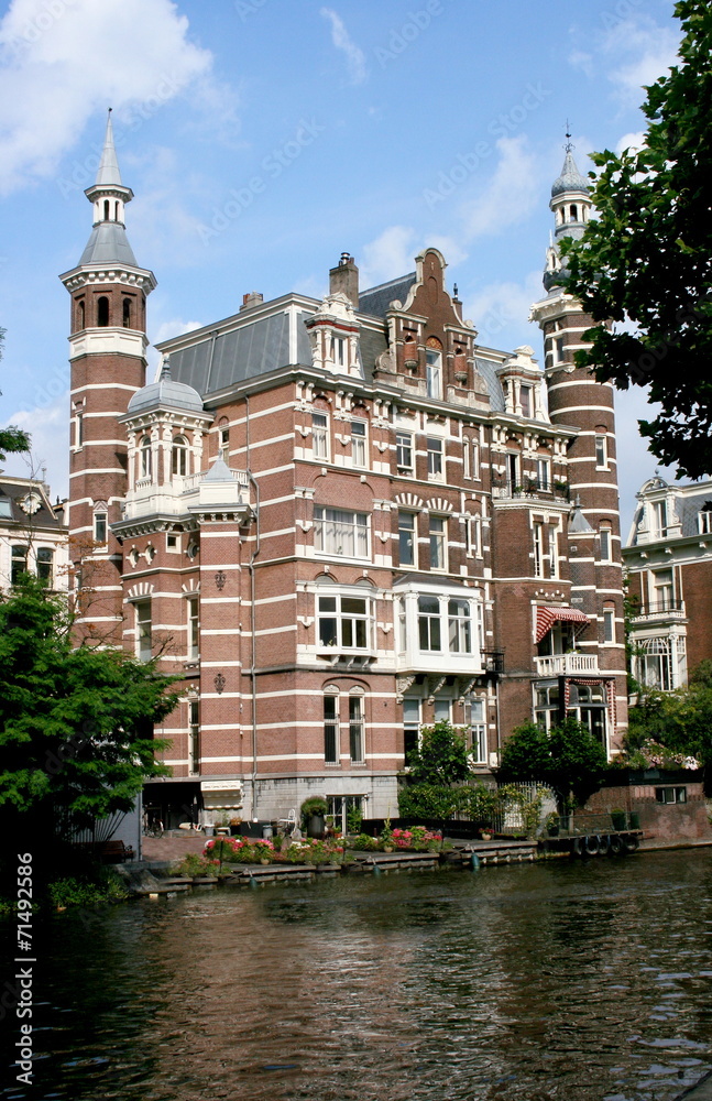 large, multi-story building on a canal