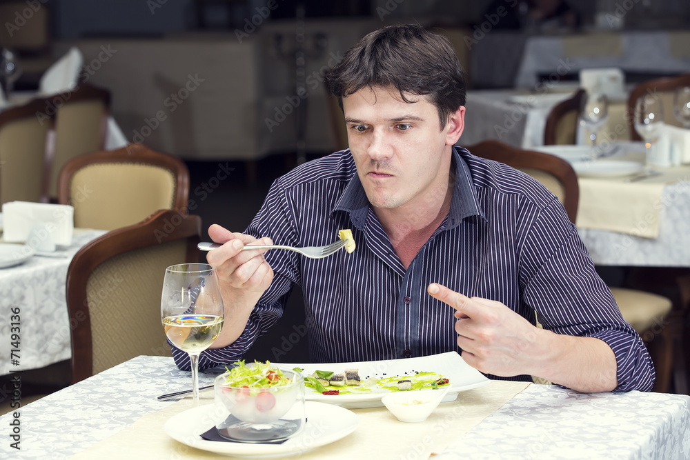 young man having dinner in a restaurant young man having dinner in a restaurant