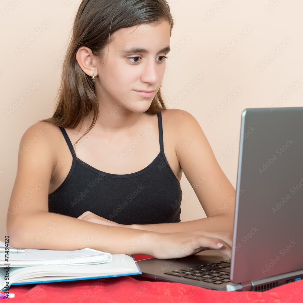 Teenage girl working on her computer at home Teenage girl working on her computer at home