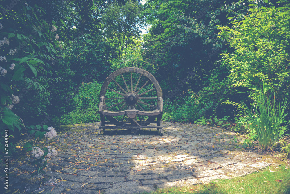 Wooden wheel ornament in Cornish garden