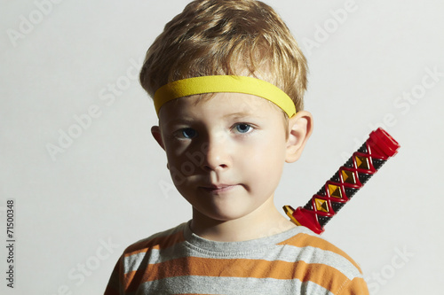 funny child play ninja.Little Boy with ninja sword.Masquerade