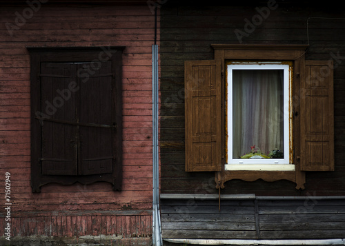 The old shabby wood closed and opened windows with shutters