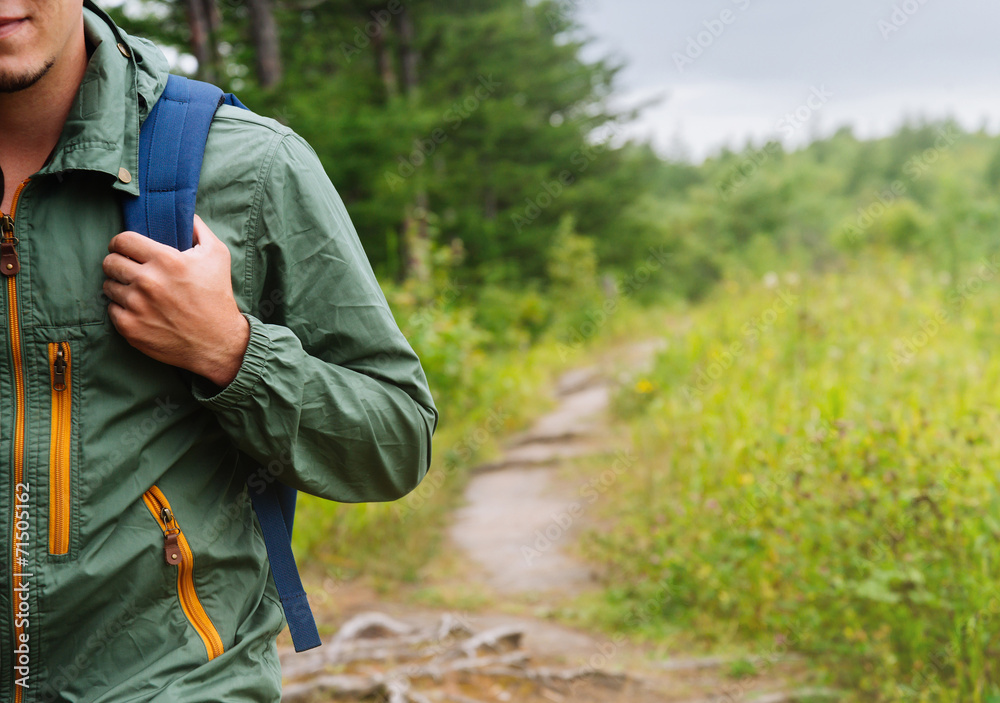 Fototapeta premium Hiker man walking on path in summer