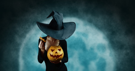 Mystery witch opening Halloween carved pumpkin