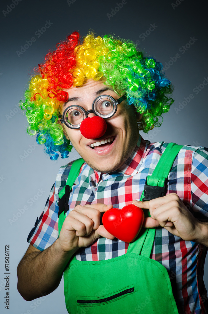 Clown with red heart in romantic concept Clown with red heart in romantic concept