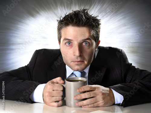 Fotografija addict businessman holding coffee cup in caffeine addiction