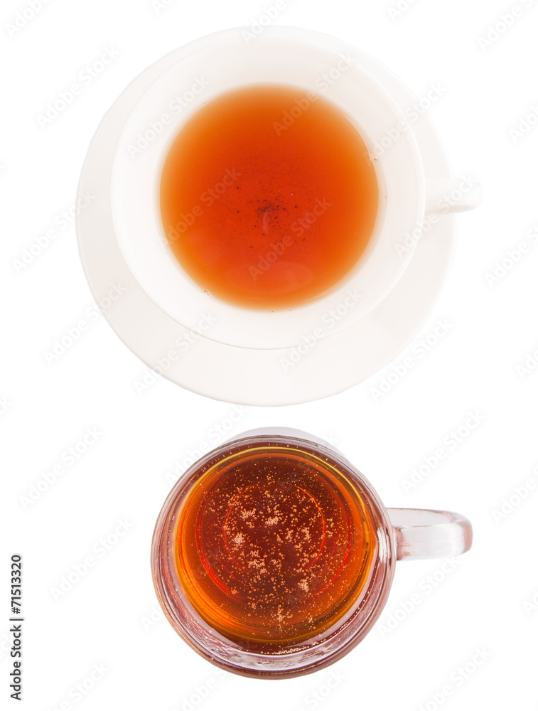 A cup of tea and a jar of honey over white background