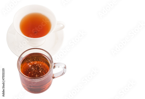 A cup of tea and a jar of honey over white background