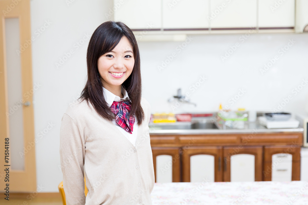 young asian woman relaxing in the kitchen