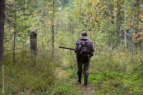 hunter shooting on the walk in forest