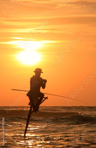 Silhouette of a stick fisherman at sunset, Unawatuna, Sri Lanka