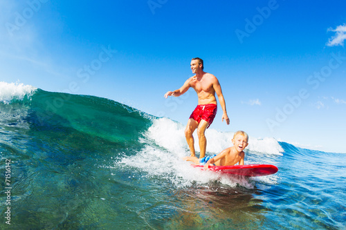 Father and Son Surfing, Riding Wave Together © EpicStockMedia
